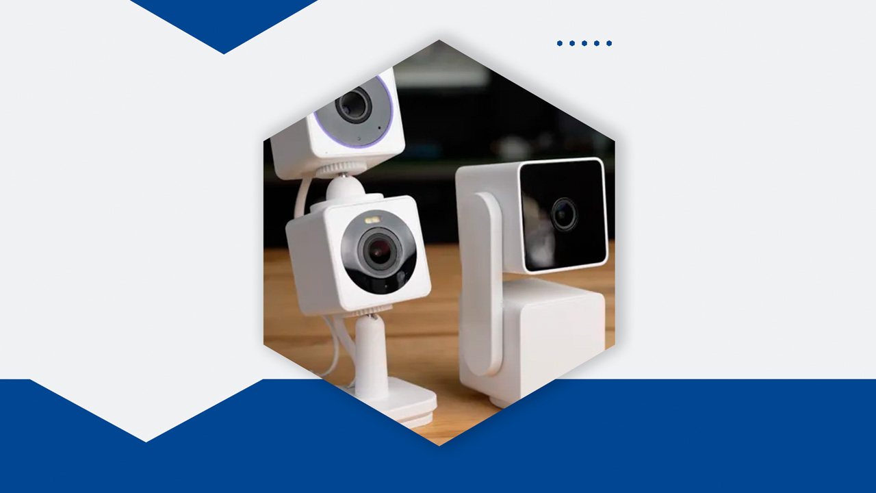 Wyze Cam v3 placed on a shelf with its app open on a phone.
