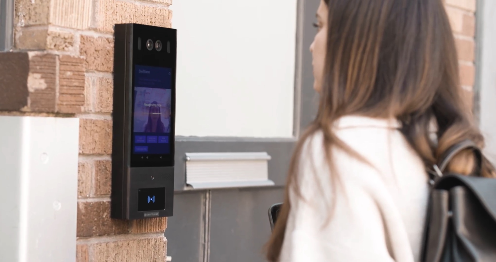 Installer mounting cameras and video doorbell on a San Francisco home at dusk with Bay or skyline visible in background. Home Security Installers San Francisco