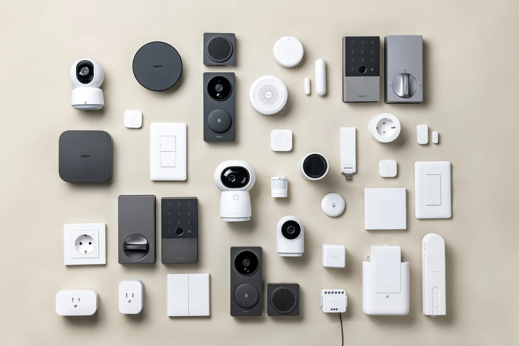 A smart home starter kit with smart bulbs, a hub, and security devices on a table.Smart Home Kits