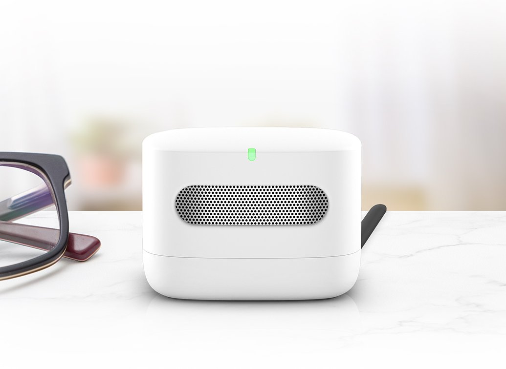 Amazon Smart Air Quality Monitor on a shelf displaying good air quality with Alexa app visible.