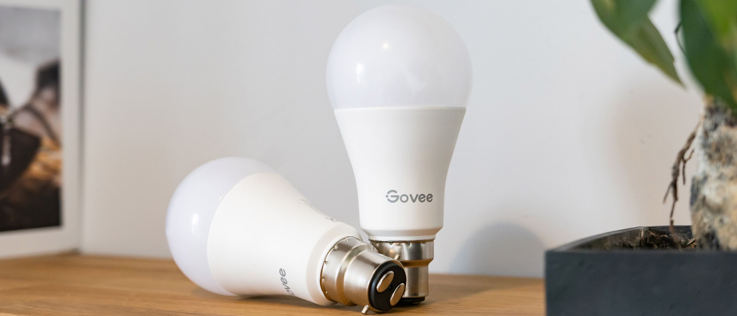 Govee Smart Color Changing Light Bulbs 4-pack shown in use in home lamps.